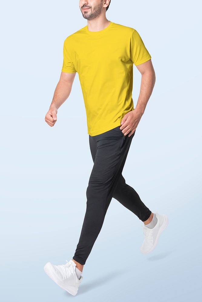 Man in yellow t-shirt and black pants sportswear fashion