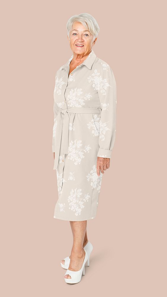 Senior woman in beige shirt dress with floral pattern apparel with design space