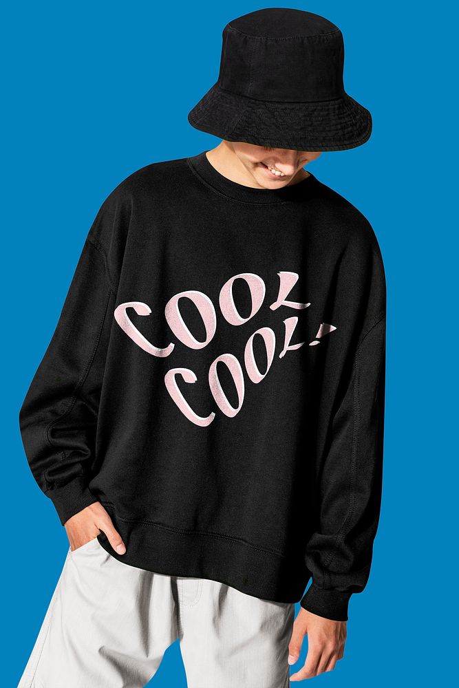 Young man in black sweater with COOL typography winter apparel shoot