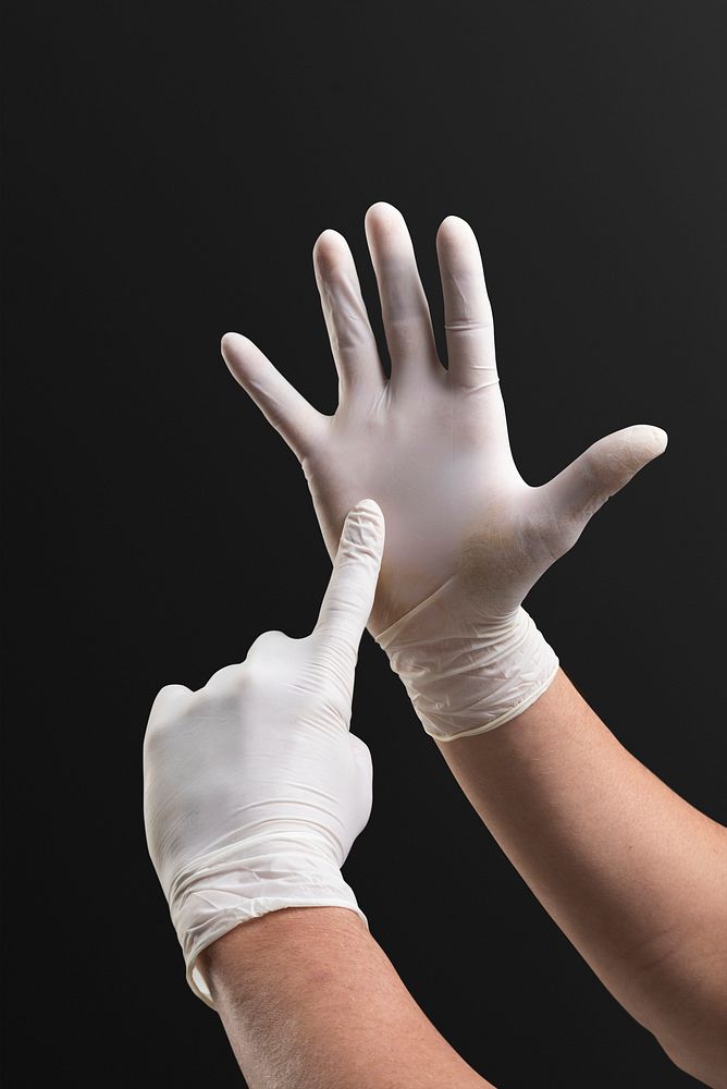 Hands wearing medical gloves using invisible screen