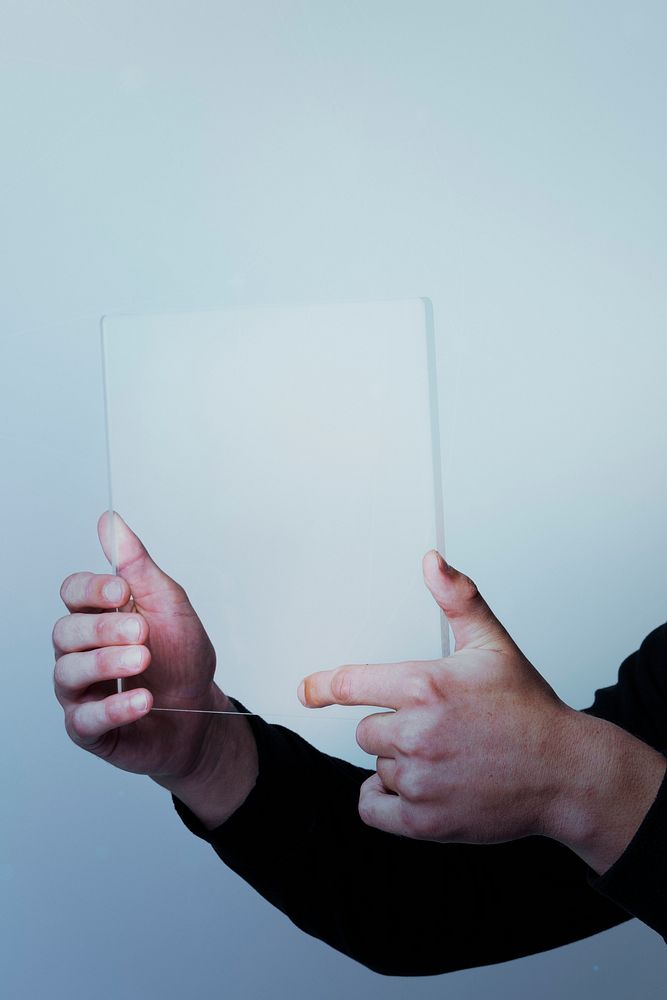 Man using a transparent  tablet digital device