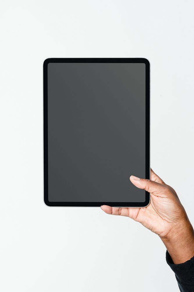 Hand holding digital tablet with blank black screen