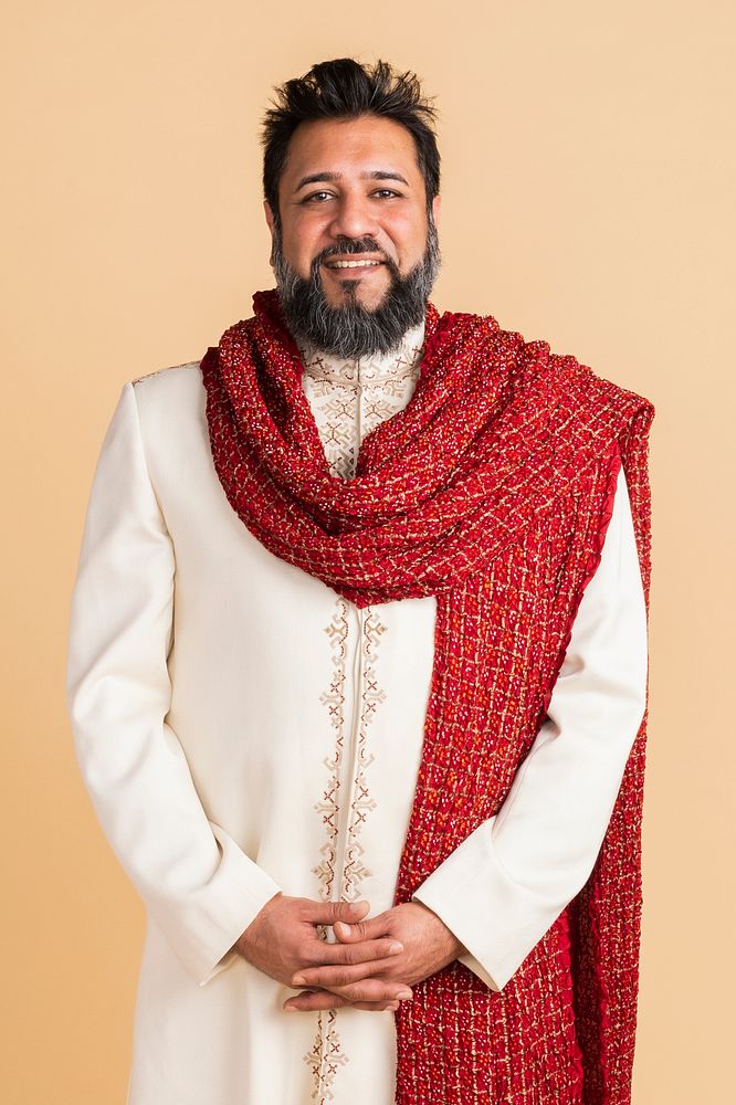 Happy Indian man wearing a kurta with a red scarf 