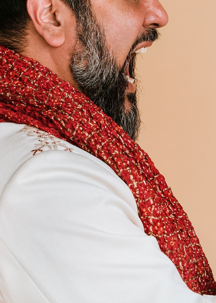 Angry Indian man wearing a kurta with a red scarf 