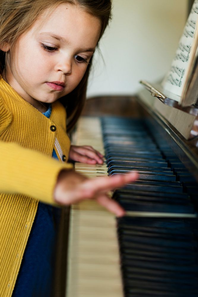 Cute little girl playing piano