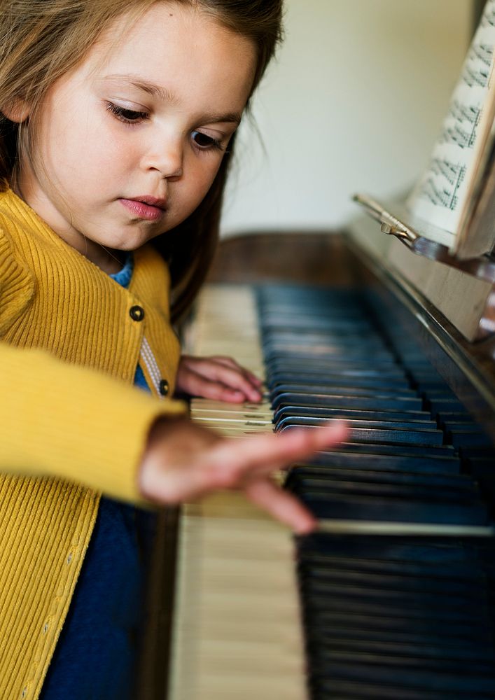 Cute little girl playing piano