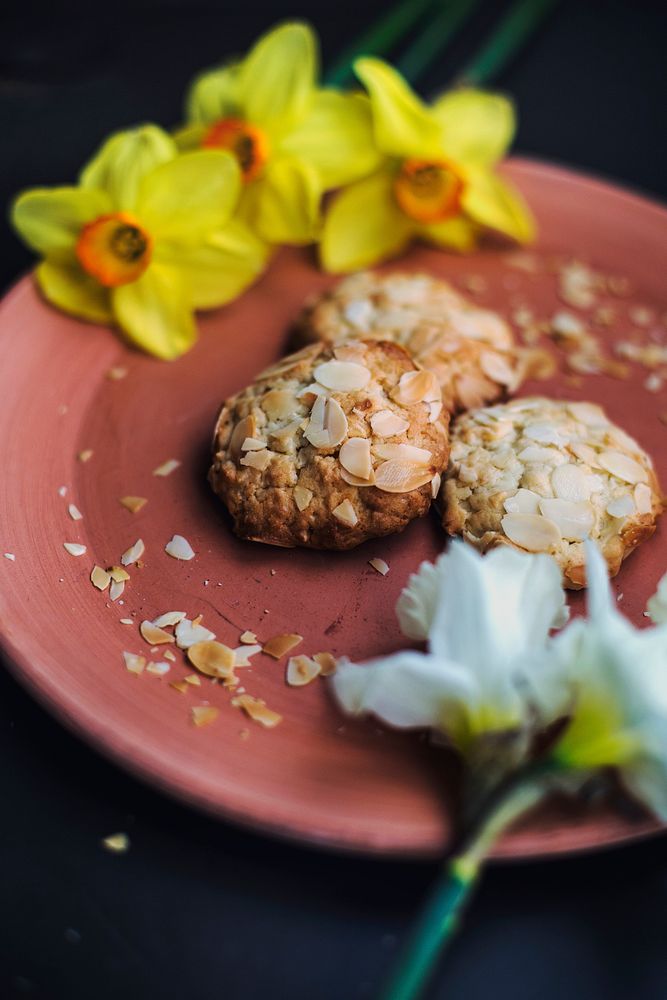Almond cookies on a pink plate with yellow flowers. Original public domain image from Wikimedia Commons