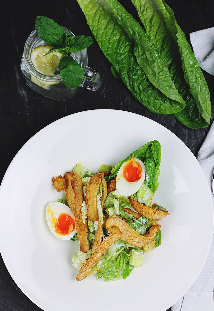 Salad with sauteed chicken, soft boiled eggs, and lettuce. Original public domain image from Wikimedia Commons