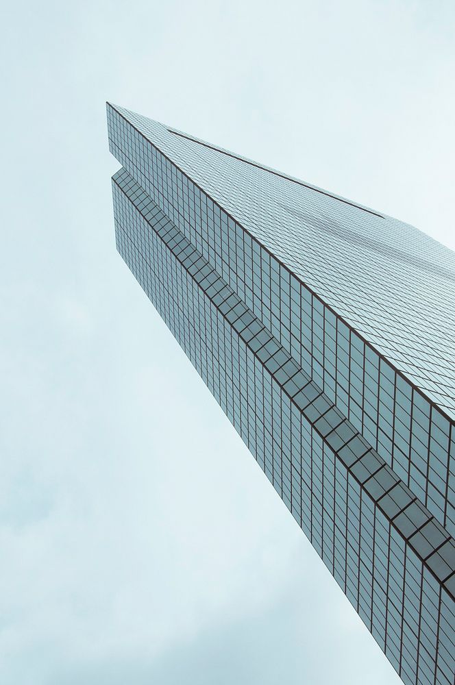An angular shot of a skyscraper under a cloudy sky. Original public domain image from Wikimedia Commons