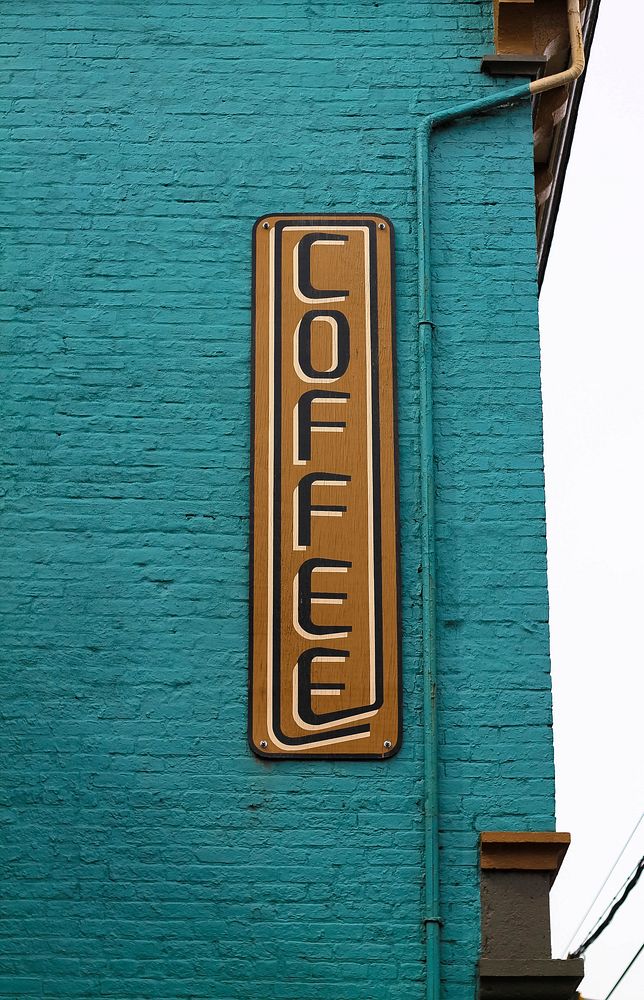 The sign reads "COFFEE" on the turquoise wall of the Ghostlight Coffee.. Original public domain image from Wikimedia Commons