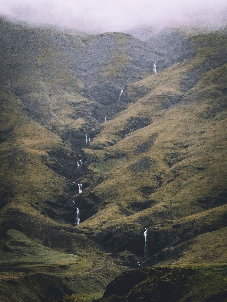 Line of waterfalls in the green, grassy mountains of Iceland. Original public domain image from Wikimedia Commons