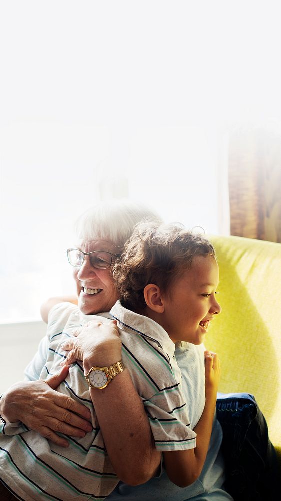 Grandma and grandson hugging after social distancing text space