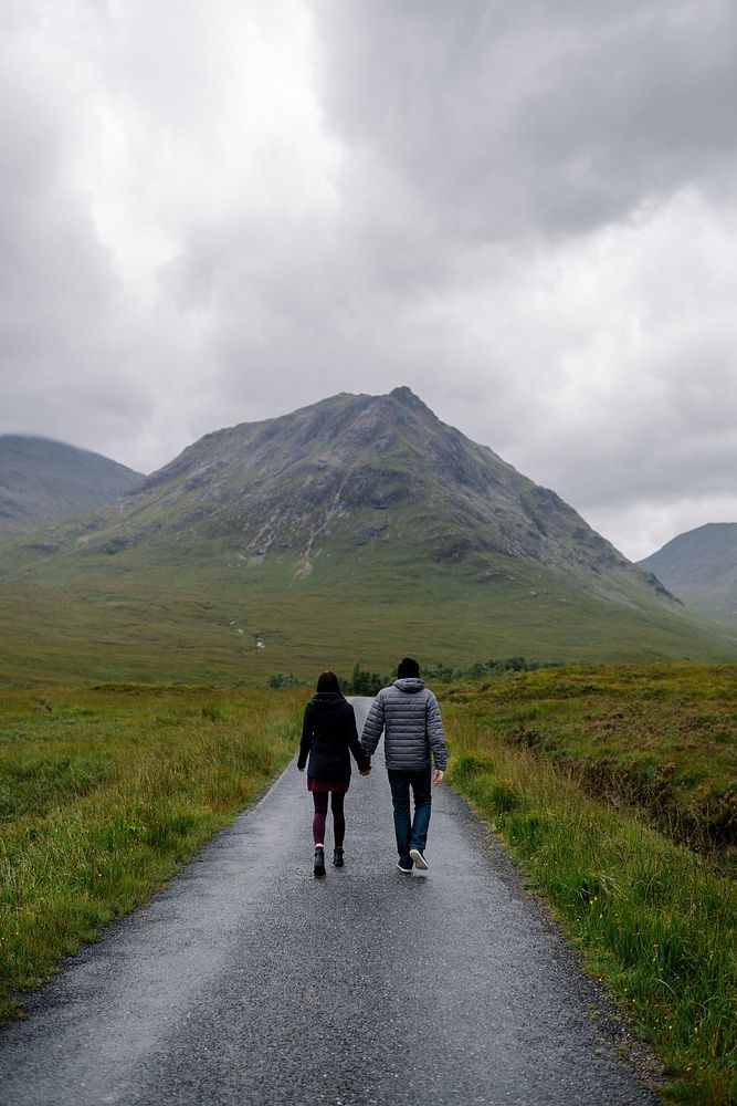 Couple walking through the rain in Glen Etive, Scotland