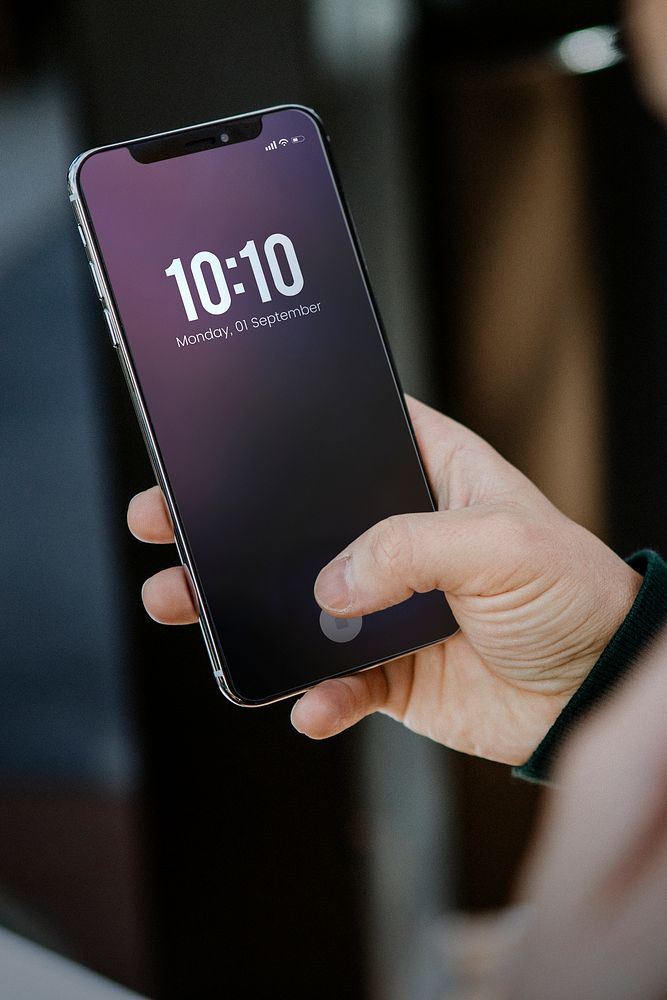 Man using a mobile phone to check the time 