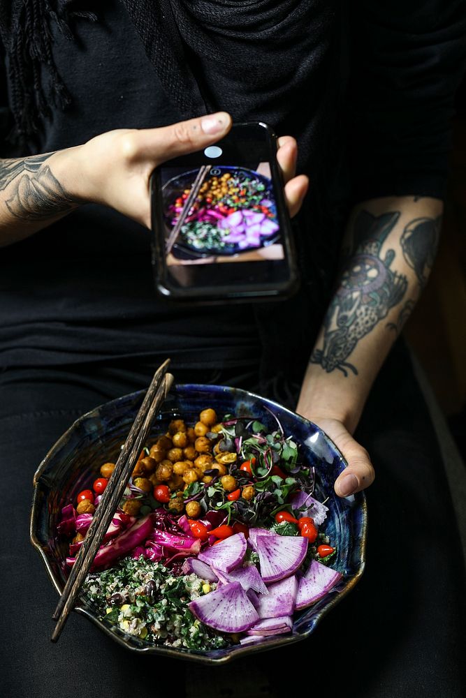 Woman taking a picture of an organic buddha bowl