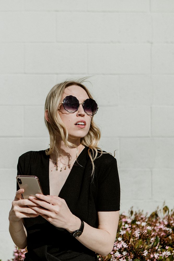 Woman with a sunglasses using her phone