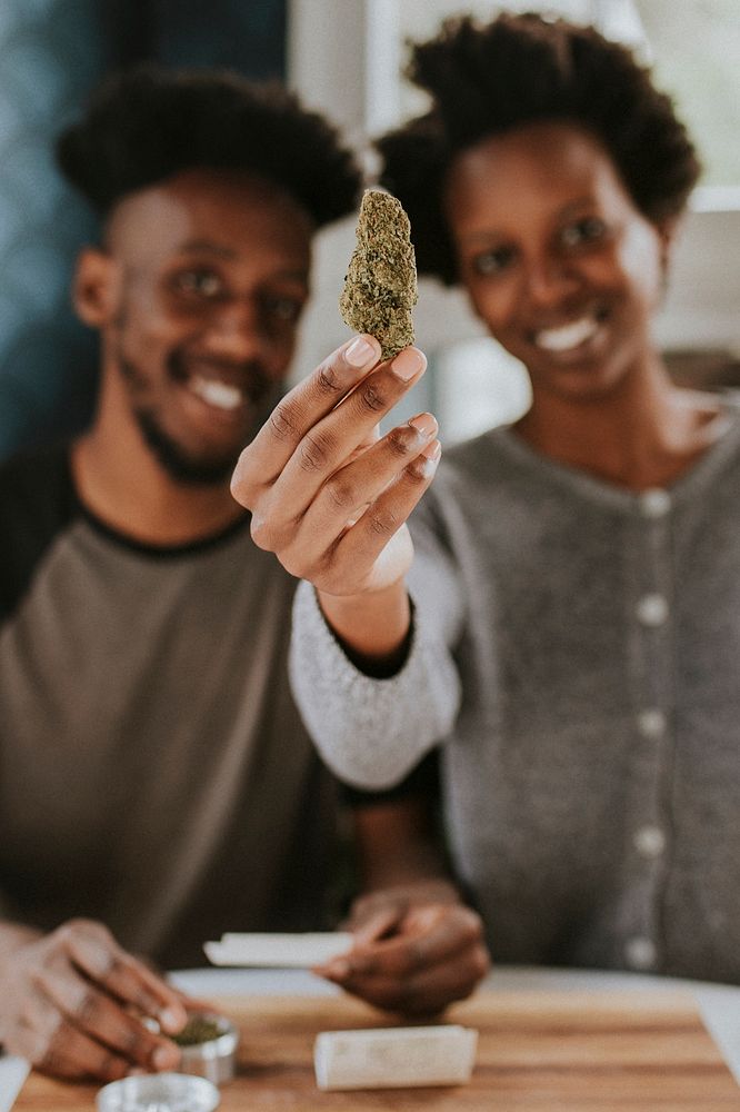 A couple rolling a joint