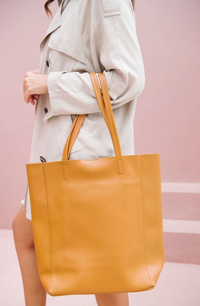 Woman carrying a brown handbag