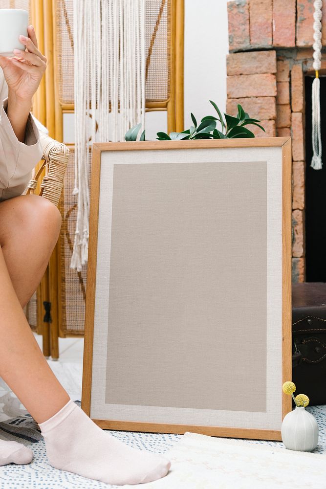 Woman sitting by a picture frame