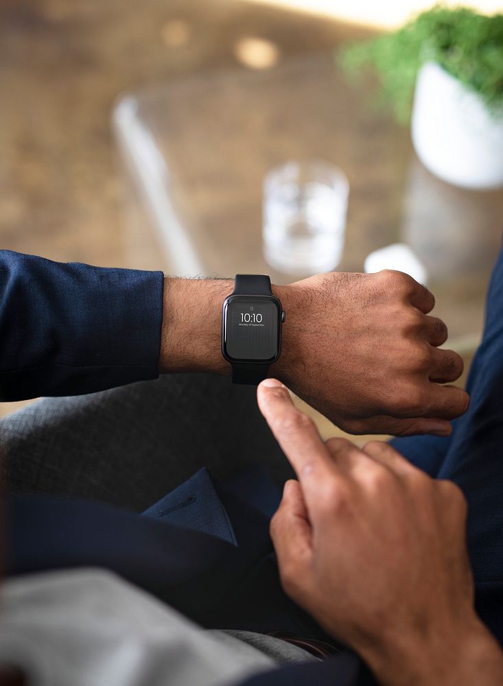 Businessman using his smartwatch in the office