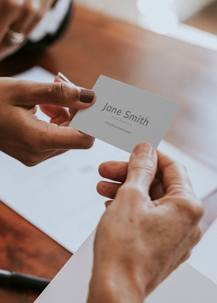 Woman handing a business card