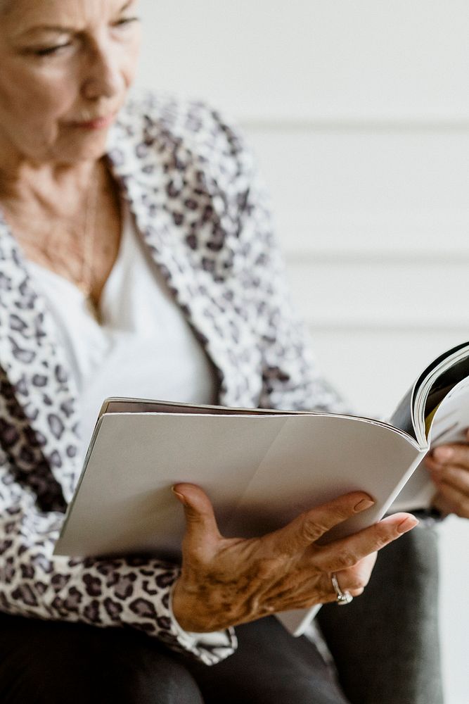 Old woman reading a magazine