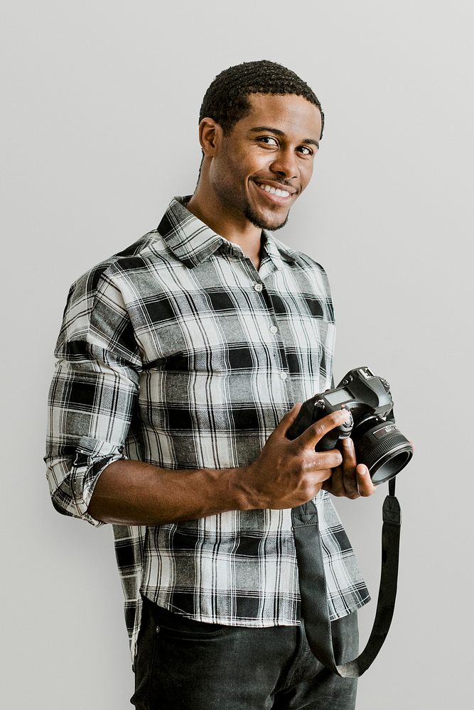 Male photographer holding a camera mockup