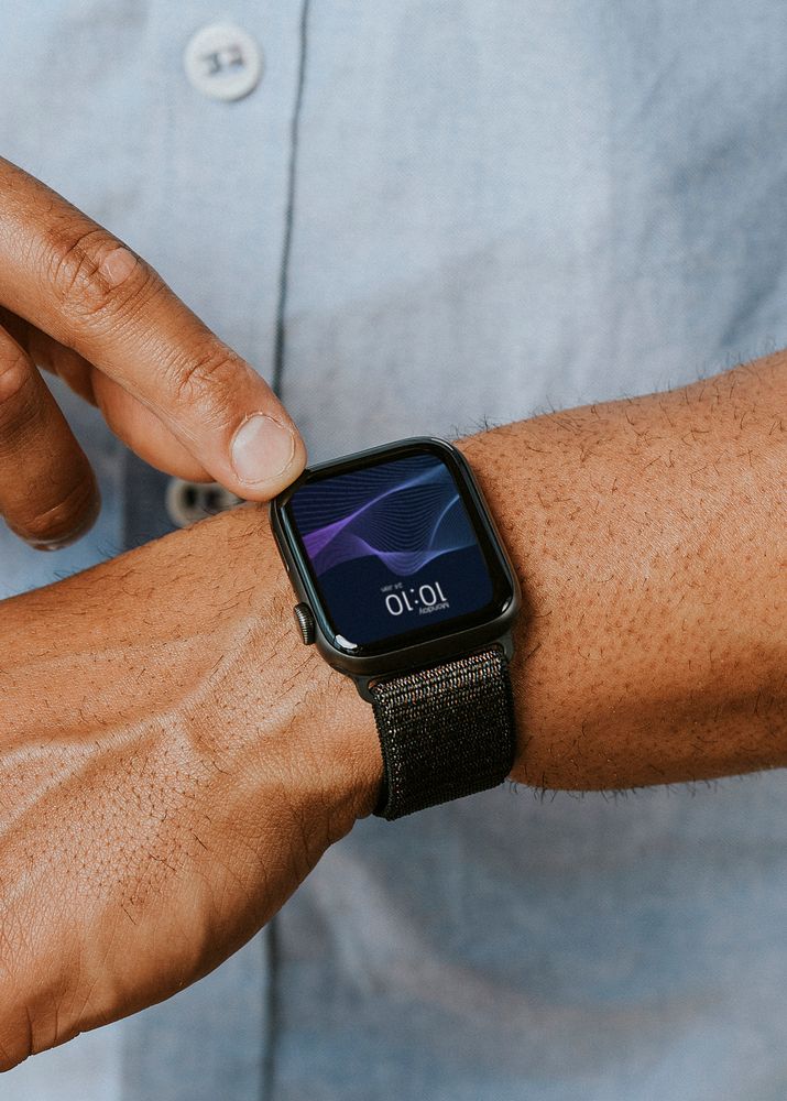 Man in a blue shirt using his smartwatch