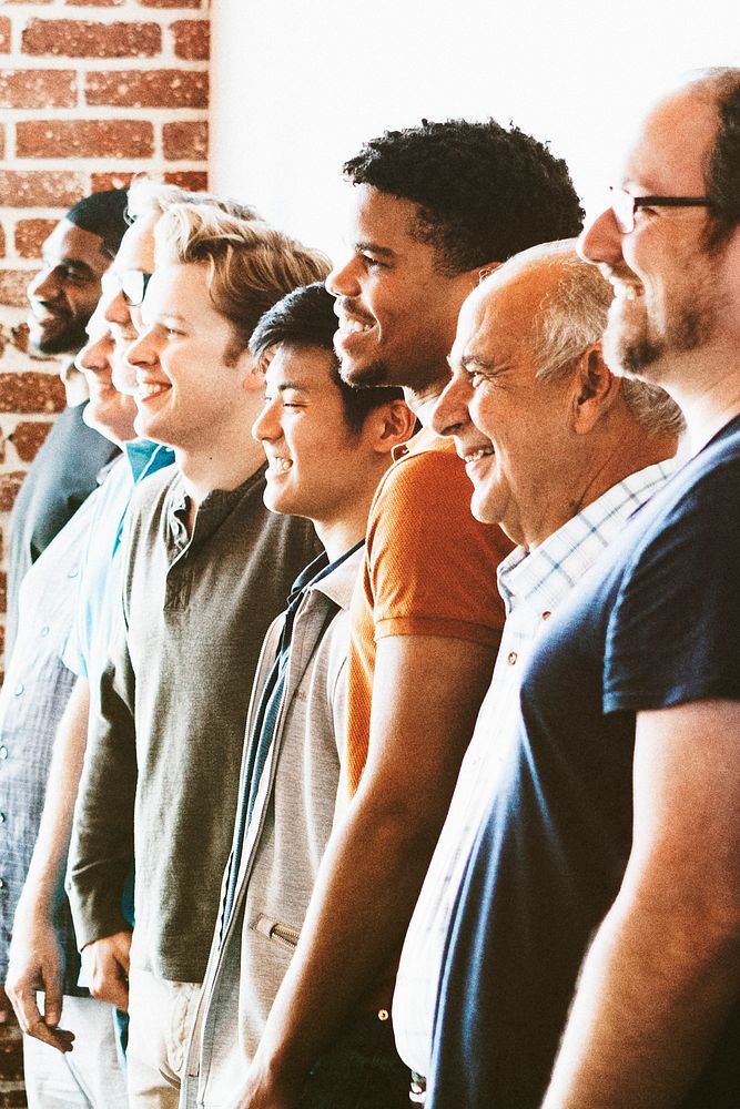 Cheerful diverse men standing in a row