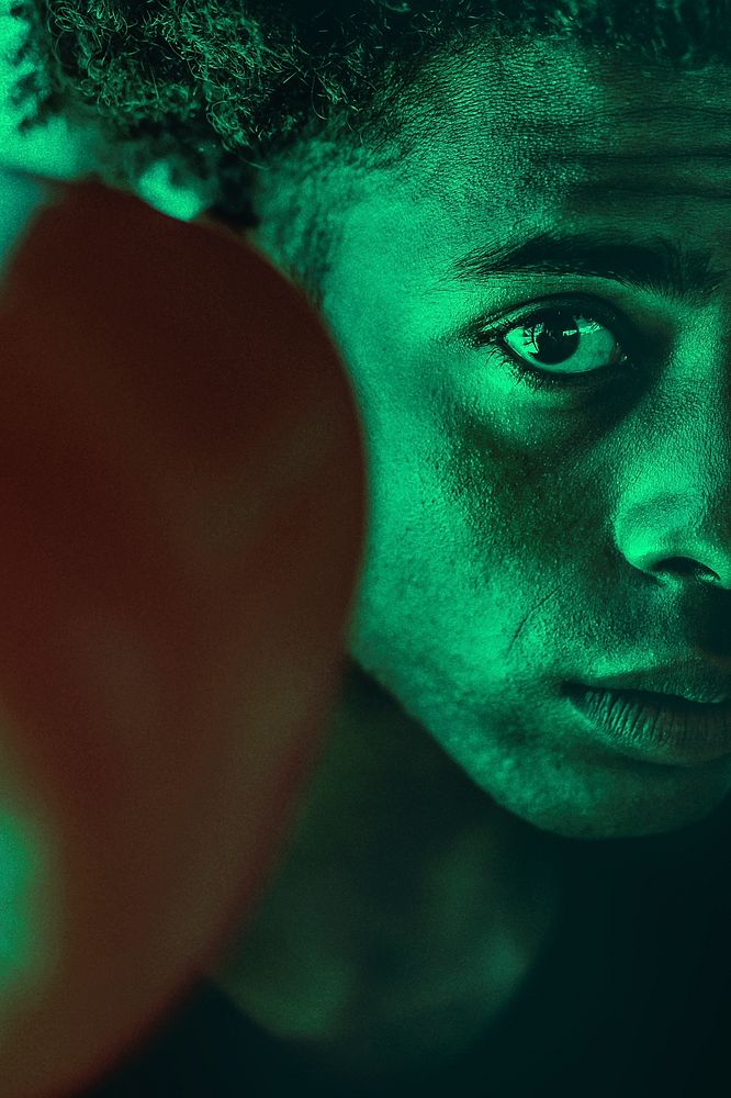 Half-face portrait of boxer in green