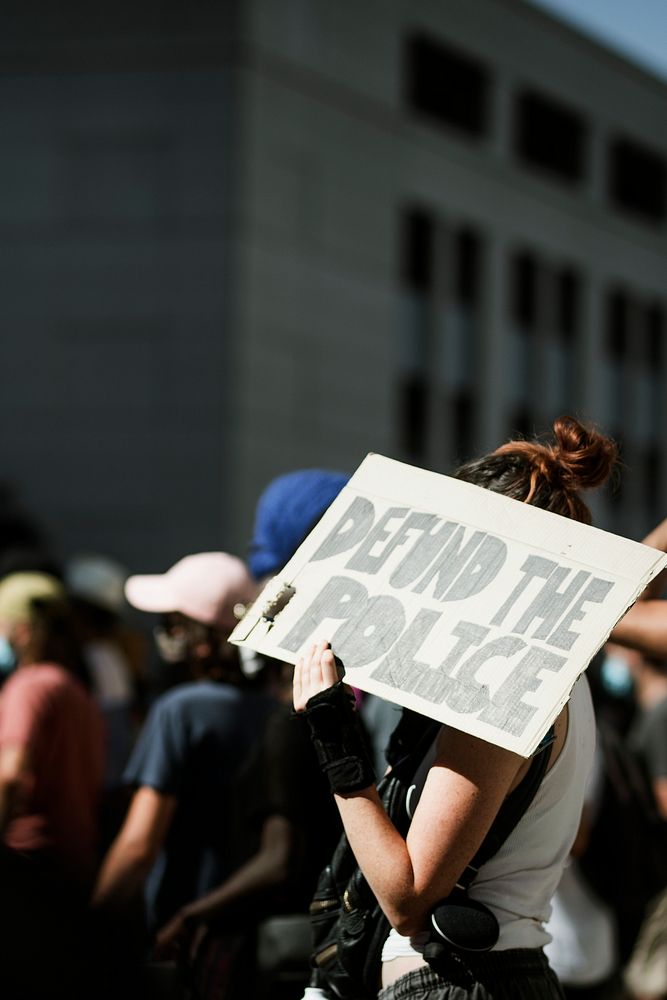 Defund the police on a board at a black lives matter protest 