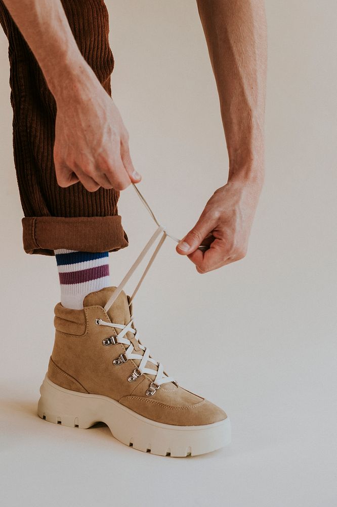 Model tying shoelaces suede sneaker