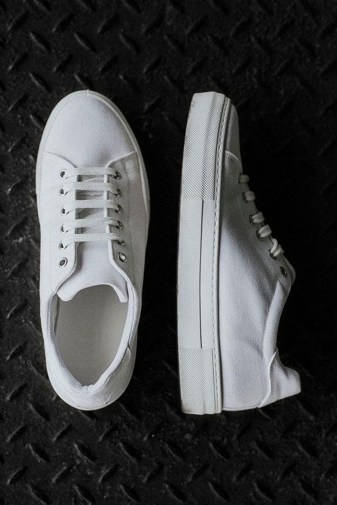 White canvas sneakers on metal floor