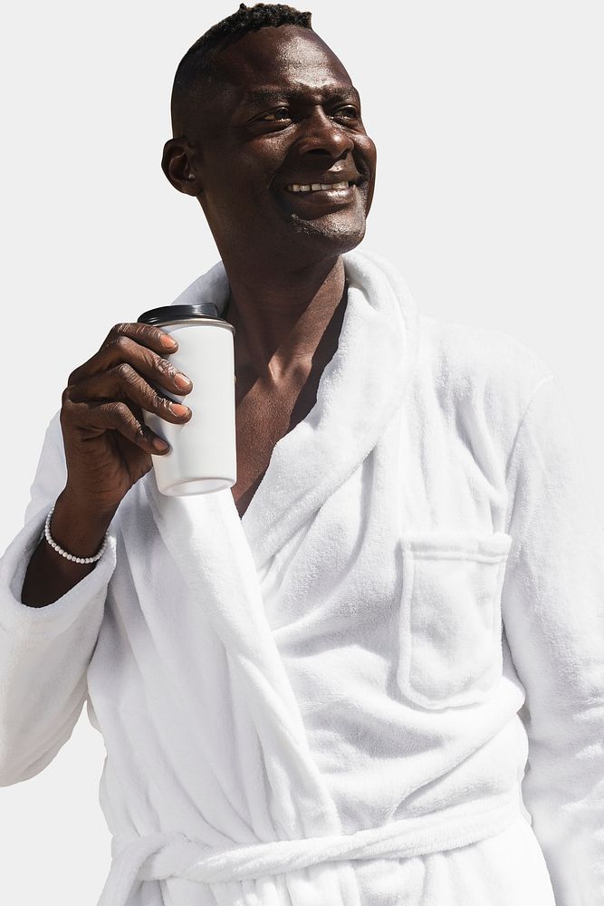 African American senior man in a bathrobe drinking coffee isolated on white background