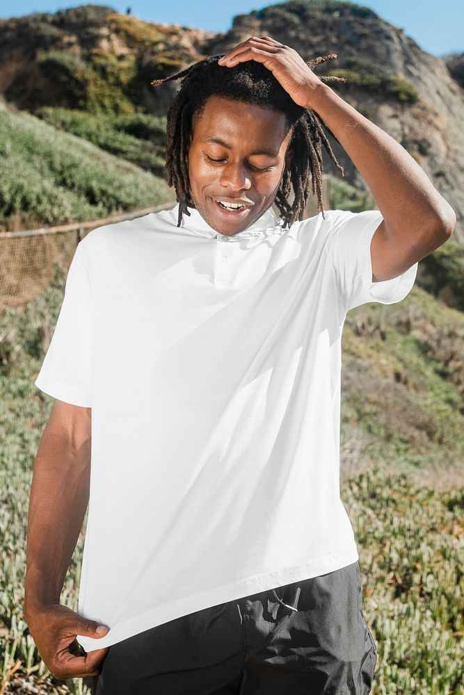 African American man in white polo shirt summer fashion outdoor photoshoot