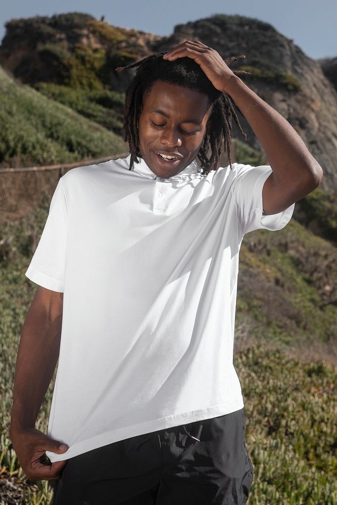 African American man in white polo shirt summer fashion outdoor photoshoot