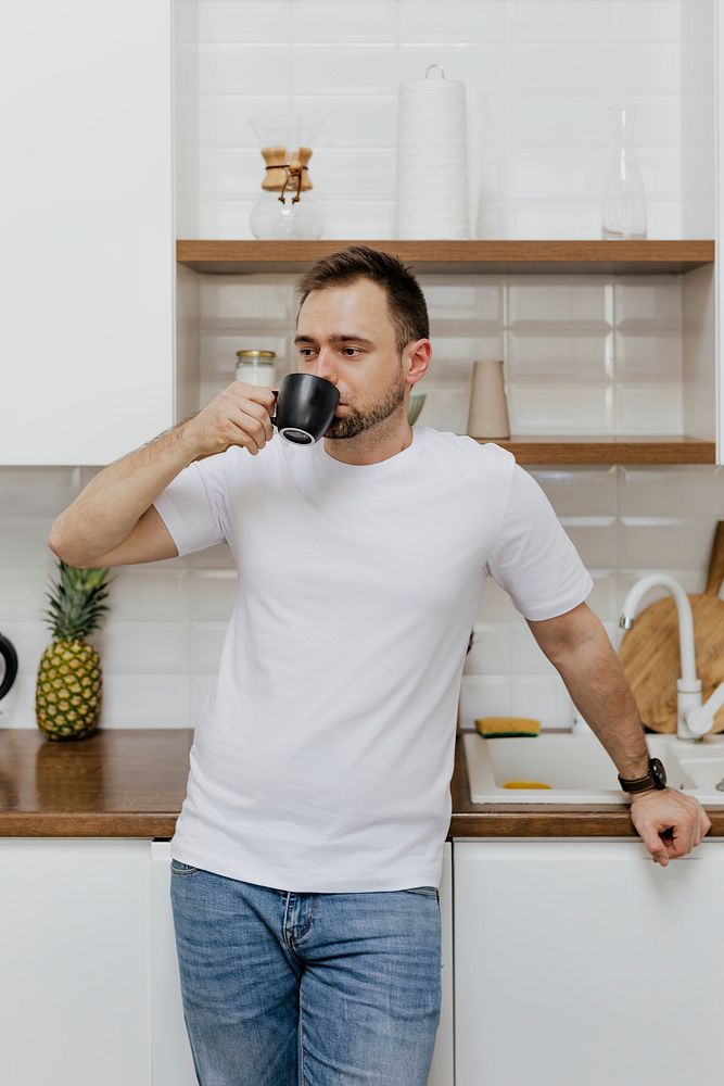 Man drinking coffee in the kitchen