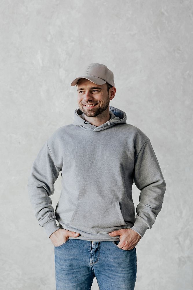 Happy man wearing a cap and a gray hoodie