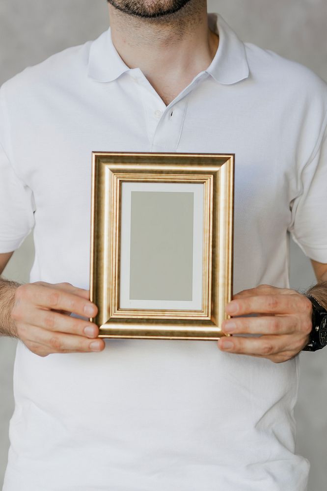 Man holding a golden frame mockup