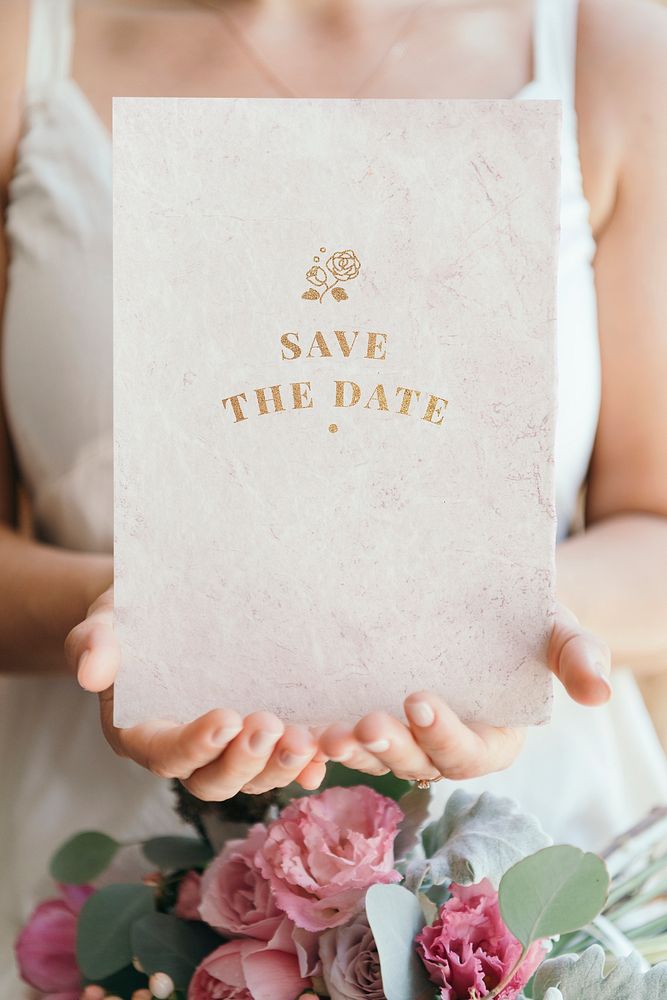 Bride holding a save the date card