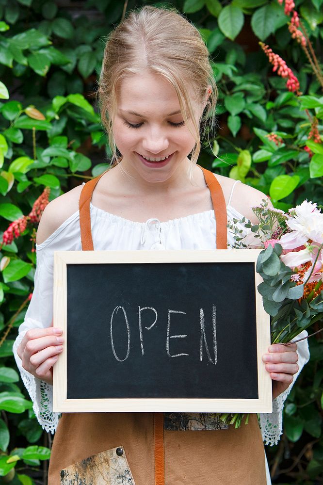 Florist holding an open board sign mockup