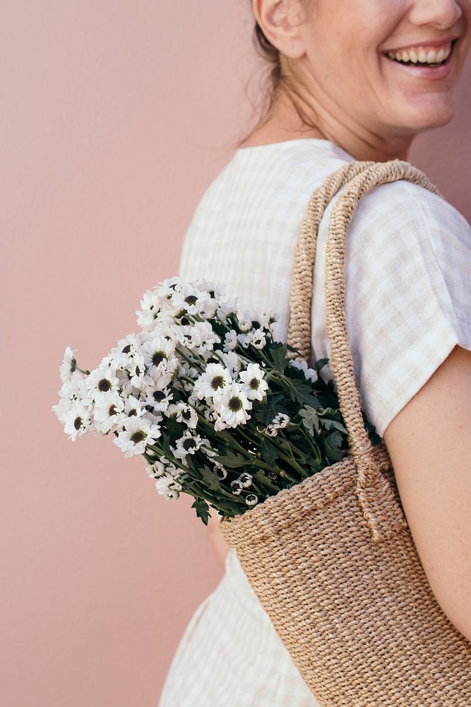 Woman with a bag of white daisy flowers