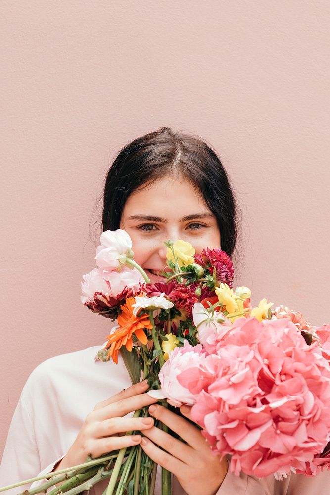 Beautiful young girl with a large pink bouquet