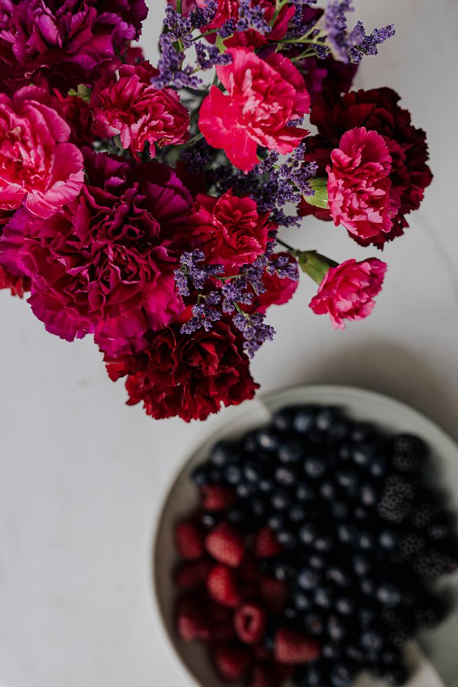 Fresh berries and flowers on the table