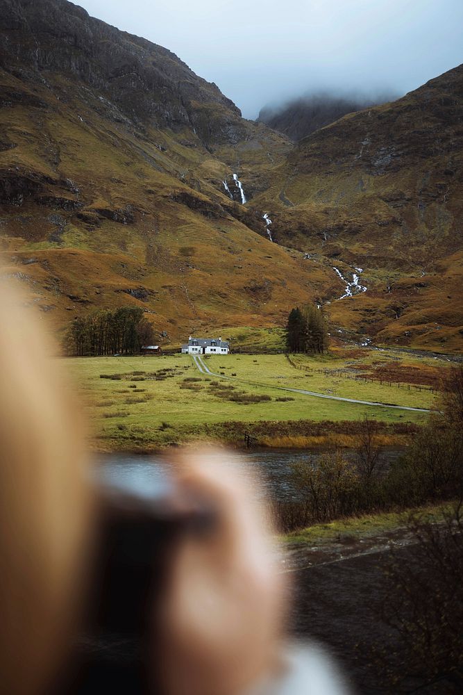 Photographer snapping  countryside view of Glencoe, Scotland
