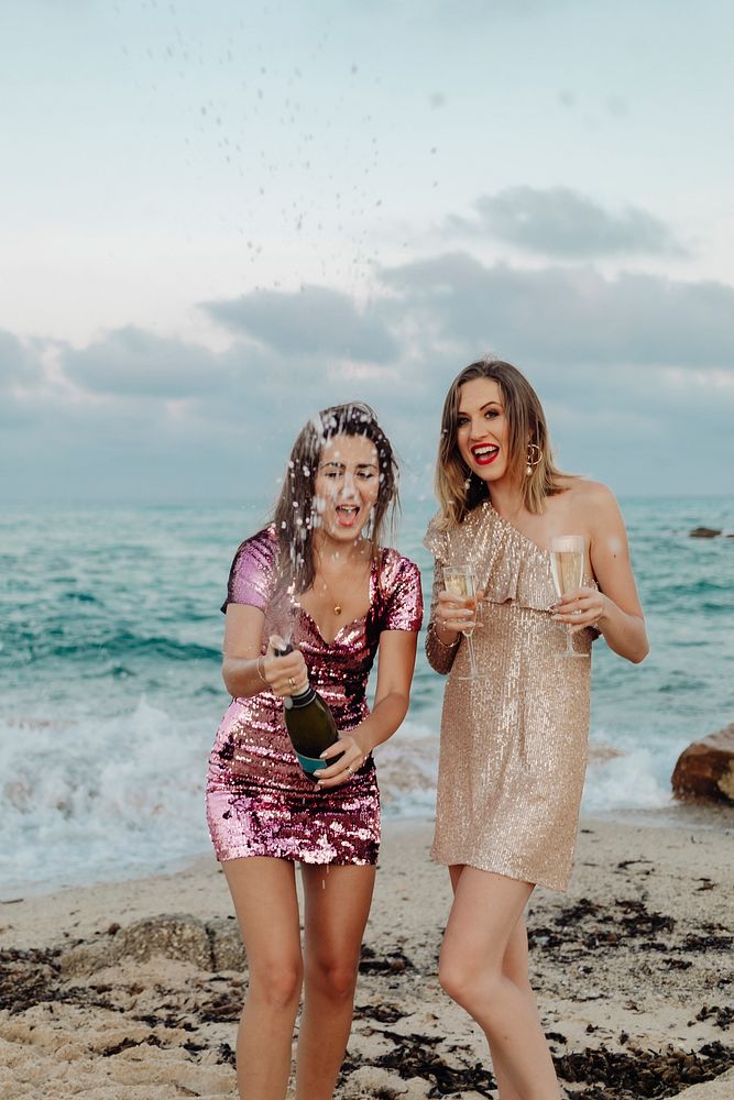 Women with champagne at the beach