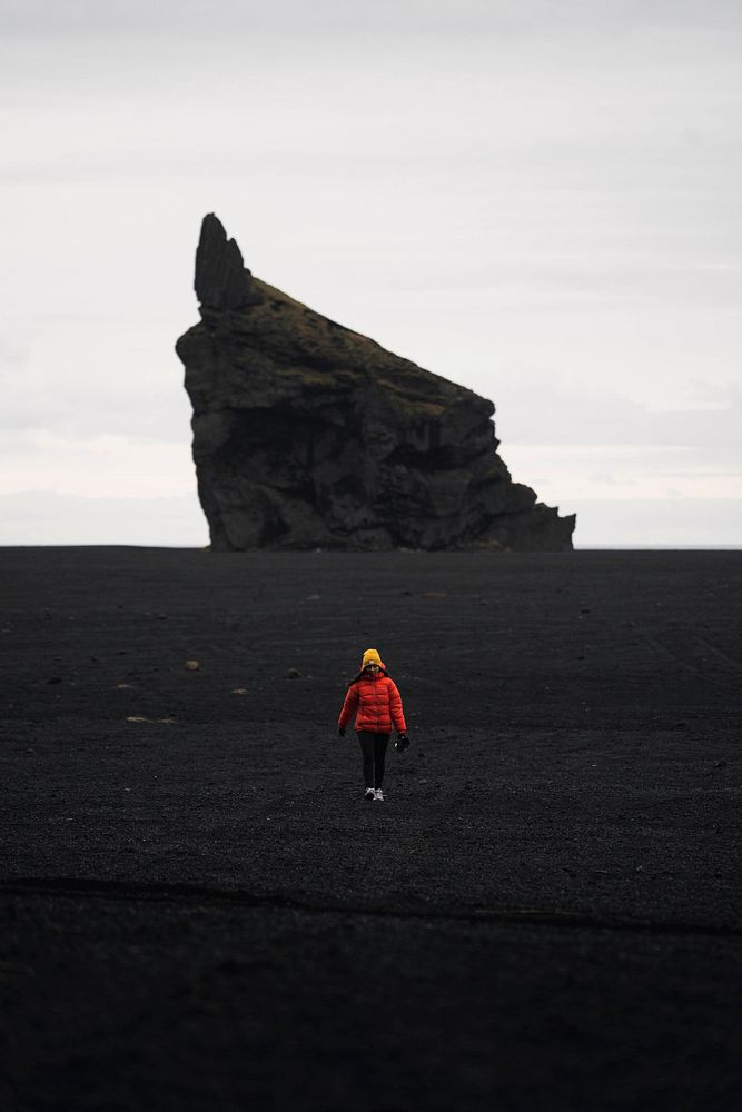 Female photographer at the black sand beach in Iceland