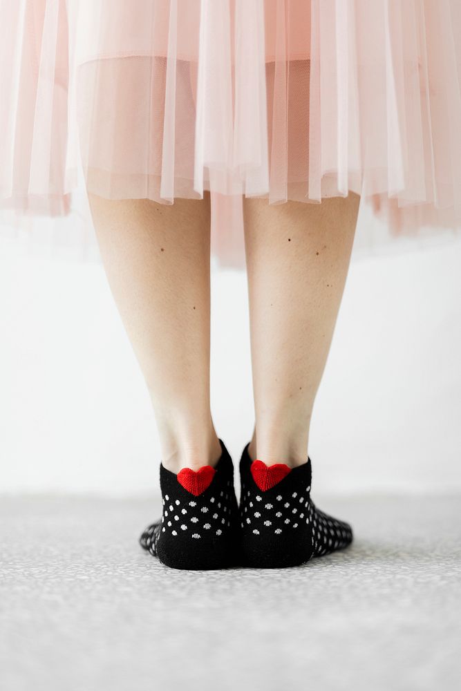 Woman in black socks with little red hearts 