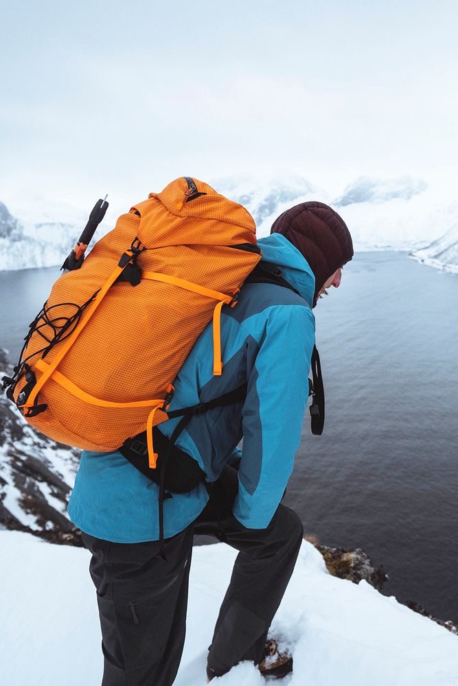 Backpacker hiking up Segla mountain, Norway