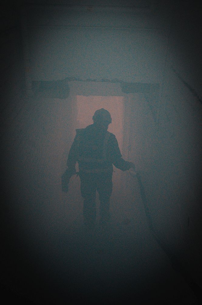 Firefighter in smoke. Original public domain image from Flickr